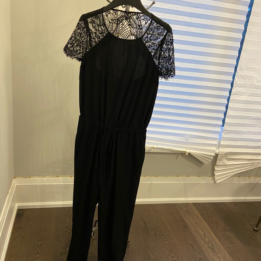 Black jumpsuit with lace around the top